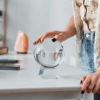 cropped-view-of-soothsayer-touching-orb-near-candl-2023-11-27-05-26-17-utc-1024x683